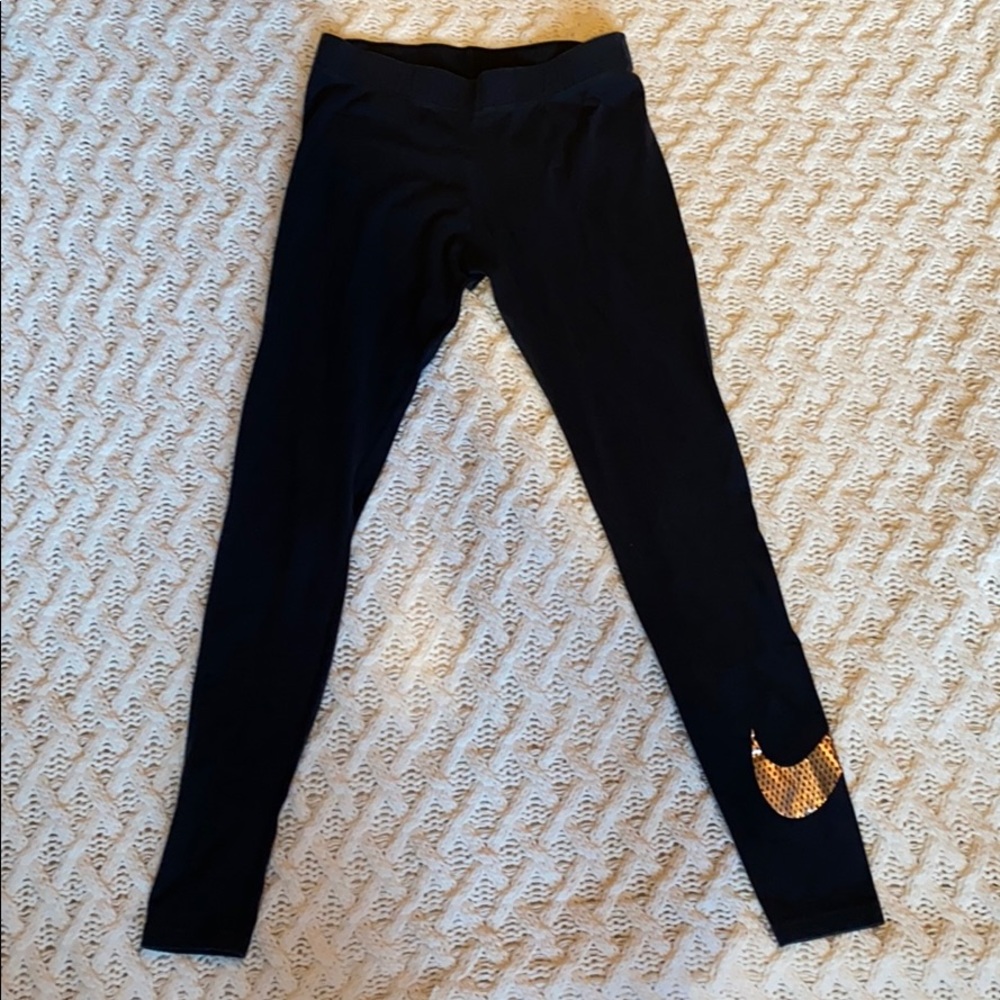 Nike leggings with metallic gold swoosh